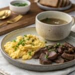scrambled eggs and beef liver on stone plate with bone broth