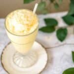 top-down view of frothy carnivore smoothie with straw and creamy foam